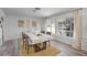 Spacious dining area with wood table and chairs, neutral decor, and large windows at 1642 Athens St, Lakeland, FL 33803