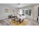 Bright dining room with wood table, neutral decor, and large windows at 1642 Athens St, Lakeland, FL 33803