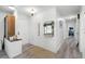 Entryway with white brick accent wall, wood-look floors, and a small sitting area at 1642 Athens St, Lakeland, FL 33803