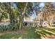 Landscaped yard with a mid-century modern home, showcasing large windows and mature trees at 1642 Athens St, Lakeland, FL 33803