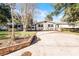 Charming ranch house with brick facade and spacious driveway, surrounded by trees at 1642 Athens St, Lakeland, FL 33803
