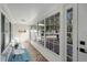 Bright and airy front porch with tiled floor, seating area, and expansive windows at 1642 Athens St, Lakeland, FL 33803