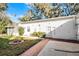 White house exterior with a spacious backyard and fire pit at 1642 Athens St, Lakeland, FL 33803