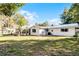 Backyard view of a ranch style home with a screened porch at 1642 Athens St, Lakeland, FL 33803