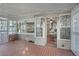 Cozy screened porch offers outdoor access and brick flooring at 1642 Athens St, Lakeland, FL 33803