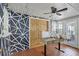 Sunroom features a desk, geometric wall art, and brick flooring at 1642 Athens St, Lakeland, FL 33803