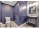 Stylish powder room features dark vanity and navy walls at 16685 Oakboro St, Winter Garden, FL 34787