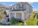 Two-story house with gray shutters, a covered porch and a landscaped yard at 16685 Oakboro St, Winter Garden, FL 34787