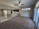 Open living room with carpet, kitchen view and access to patio at 2809 Strand Loop Ct, Oviedo, FL 32765