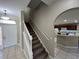 Staircase leading to the upper level with kitchen view at 2809 Strand Loop Ct, Oviedo, FL 32765