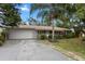Single-story home with a large driveway and lush lawn at 3116 Oranole Rd, Orlando, FL 32810