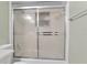 Shower with sliding glass doors and tiled walls at 3116 Oranole Rd, Orlando, FL 32810