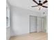 Spacious bedroom with ceiling fan, double doors to closet, and wood-look floors at 3315 Parkchester Square Blvd # 102, Orlando, FL 32835