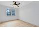 Well-lit bedroom featuring a ceiling fan and large window at 3315 Parkchester Square Blvd # 102, Orlando, FL 32835