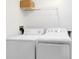 Laundry room with washer, dryer, and shelving at 3315 Parkchester Square Blvd # 102, Orlando, FL 32835