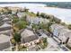 Aerial view of community with lakefront access and multiple buildings at 3433 Soho St # 204, Orlando, FL 32835