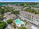 Aerial view of community showing numerous buildings and a lake at 3433 Soho St # 204, Orlando, FL 32835