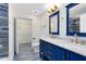 Modern bathroom with blue vanity and marble countertops at 3433 Soho St # 204, Orlando, FL 32835