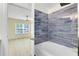 Clean bathroom with blue tile and a bathtub at 3433 Soho St # 204, Orlando, FL 32835