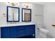 Modern bathroom with blue vanity, gold accents, and marble countertops at 3433 Soho St # 204, Orlando, FL 32835