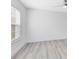 Bright bedroom with neutral walls, wood-look floors, and large window at 3433 Soho St # 204, Orlando, FL 32835