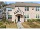 Two-story townhome with a welcoming front porch and landscaping at 3433 Soho St # 204, Orlando, FL 32835