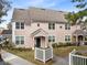 Two-story townhome with neutral exterior and white picket fence at 3433 Soho St # 204, Orlando, FL 32835