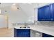 Modern kitchen with blue cabinets and stainless steel appliances at 3433 Soho St # 204, Orlando, FL 32835