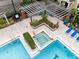 Community pool area with hot tub and pergola at 3433 Soho St # 204, Orlando, FL 32835