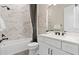 Clean bathroom with white vanity, bathtub, and marble tile at 5190 Foothills Preserve Loop, Mount Dora, FL 32757