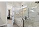 Spa-like bathroom with soaking tub, walk-in shower, and marble tile at 5190 Foothills Preserve Loop, Mount Dora, FL 32757