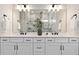 Modern bathroom featuring a double vanity and large mirror at 5190 Foothills Preserve Loop, Mount Dora, FL 32757