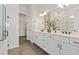 Elegant bathroom with double vanity, large mirror, and walk-in shower at 5190 Foothills Preserve Loop, Mount Dora, FL 32757