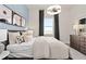 Bright bedroom with a queen bed and large window at 5190 Foothills Preserve Loop, Mount Dora, FL 32757