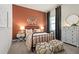 Stylish bedroom with metal bed frame and terracotta wall at 5190 Foothills Preserve Loop, Mount Dora, FL 32757