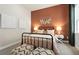Well-lit bedroom with metal bed frame and terracotta wall at 5190 Foothills Preserve Loop, Mount Dora, FL 32757