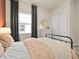 Cozy bedroom with a metal bed frame and terracotta wall at 5190 Foothills Preserve Loop, Mount Dora, FL 32757