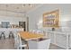 Elegant dining room with long wooden table and white shiplap wall at 5190 Foothills Preserve Loop, Mount Dora, FL 32757