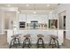 Modern kitchen with white cabinets, large island, and stainless steel appliances at 5190 Foothills Preserve Loop, Mount Dora, FL 32757
