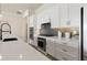 Modern kitchen with white cabinets, stainless steel appliances, and backsplash at 5190 Foothills Preserve Loop, Mount Dora, FL 32757