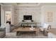 Spacious living room features a brick accent wall, comfortable seating, and a large TV at 5190 Foothills Preserve Loop, Mount Dora, FL 32757