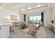 Spacious living room with large window, sofa, and access to patio at 5190 Foothills Preserve Loop, Mount Dora, FL 32757