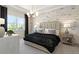 Main bedroom with cozy bed, large window and brick feature wall at 5190 Foothills Preserve Loop, Mount Dora, FL 32757