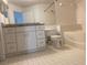 Bathroom with white cabinets, granite countertop, and bathtub at 5500 Metrowest Blvd # 101, Orlando, FL 32811