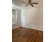 Bedroom with wood-look floors and ceiling fan at 5500 Metrowest Blvd # 101, Orlando, FL 32811