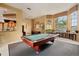 Well-lit game room, complete with a pool table at 5500 Metrowest Blvd # 101, Orlando, FL 32811