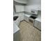 Kitchen with white cabinets, granite countertops, and appliances at 5500 Metrowest Blvd # 101, Orlando, FL 32811
