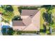 House roof and backyard; brown tile roof, well-maintained lawn at 5649 Magnolia Bloom Ter, Oviedo, FL 32765