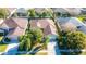 Aerial view of a house with a driveway and green lawn at 5649 Magnolia Bloom Ter, Oviedo, FL 32765
