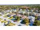 Aerial view of house and neighborhood; quiet street, tree-lined, near lake at 5649 Magnolia Bloom Ter, Oviedo, FL 32765